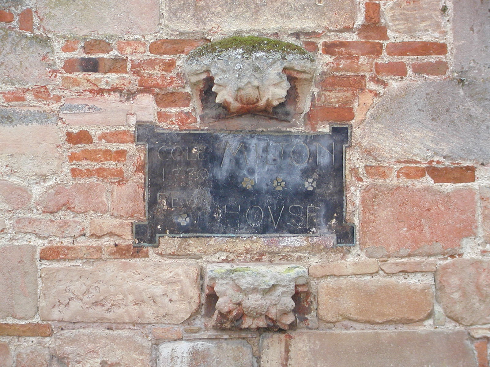 Engraved sign on wall of Milton House 